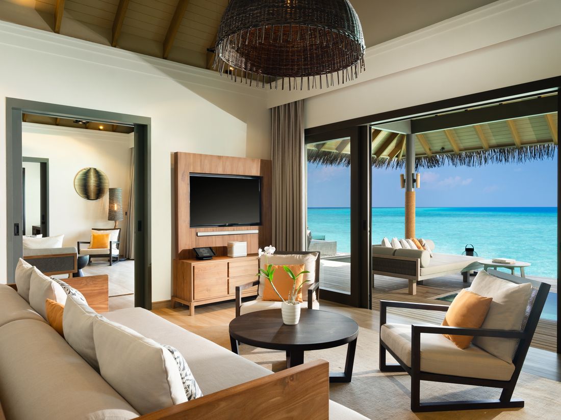 The living room of an over-water pool suite at Vakkaru Maldives
